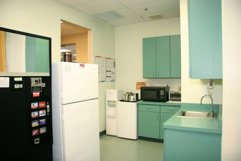 a kitchen is painted turquoise and has green accents