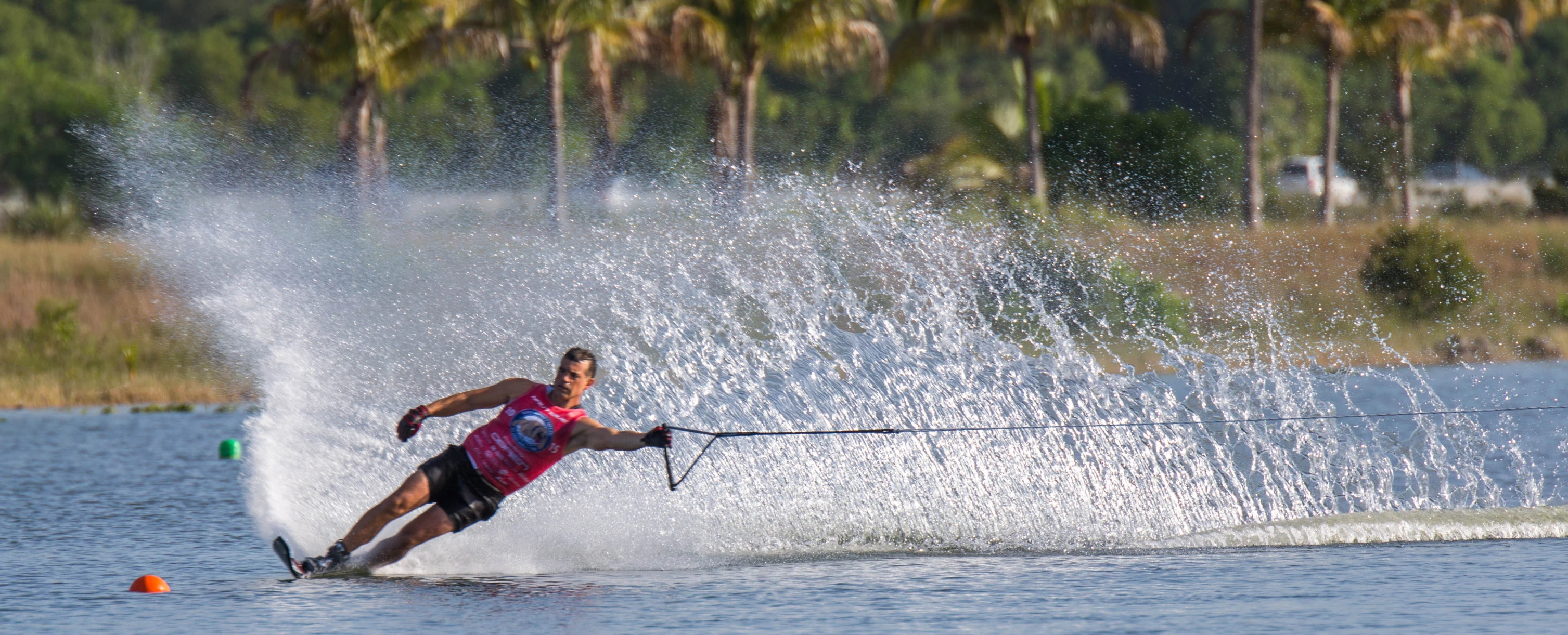 a man skiing across water behind a boat