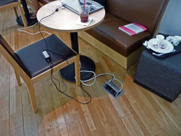 a small table in a restaurant where we are charging an outlet