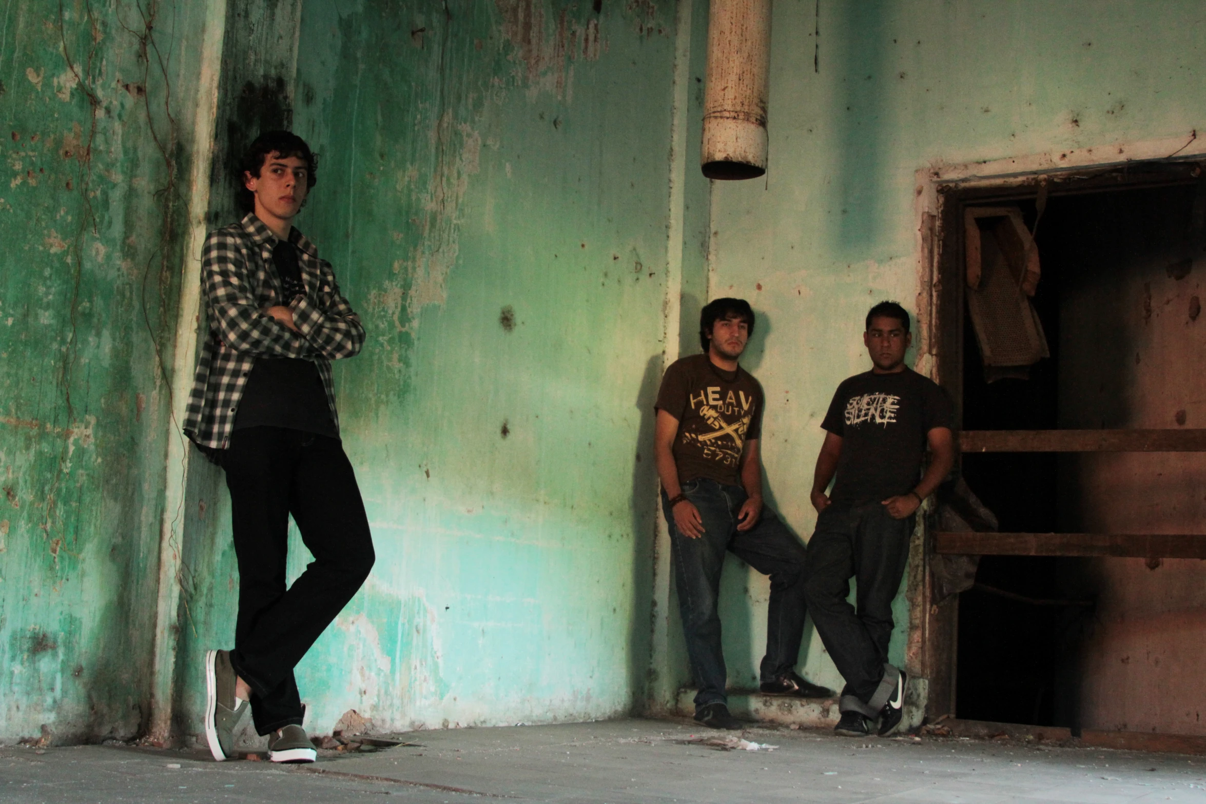 some people standing in an old building next to a door