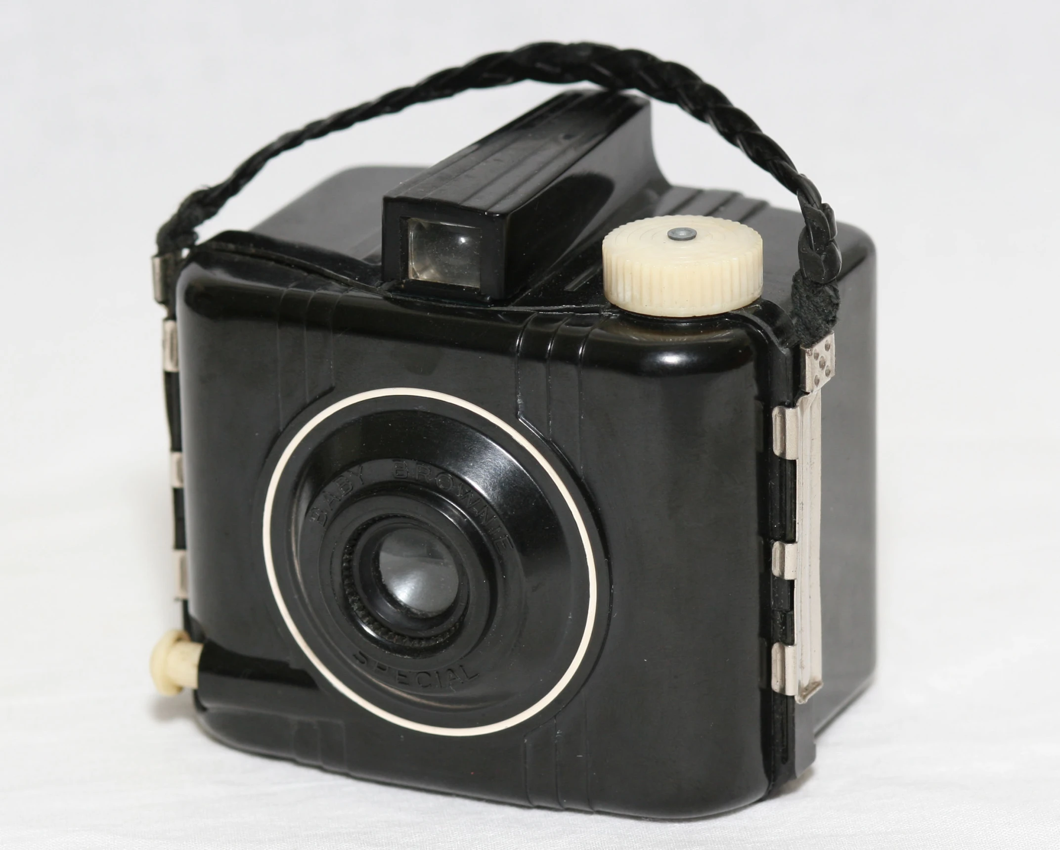 an old black camera with its lens slightly closed