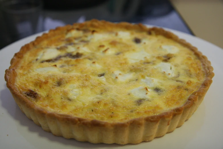 a quiche is served on a plate at a party