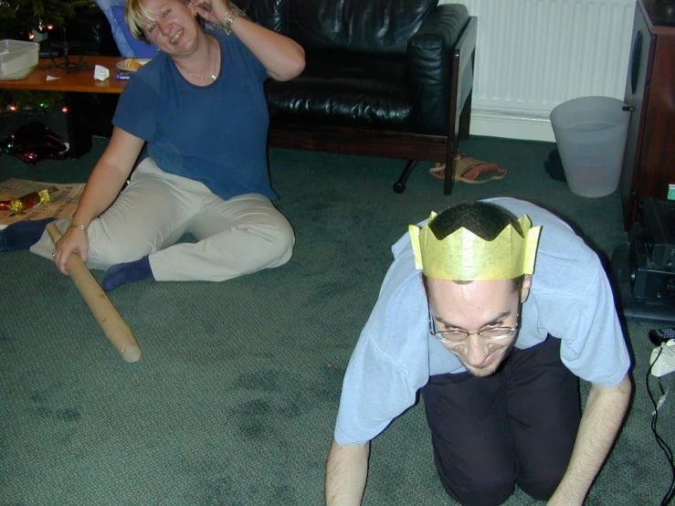 a woman wearing a crown while looking at a cell phone