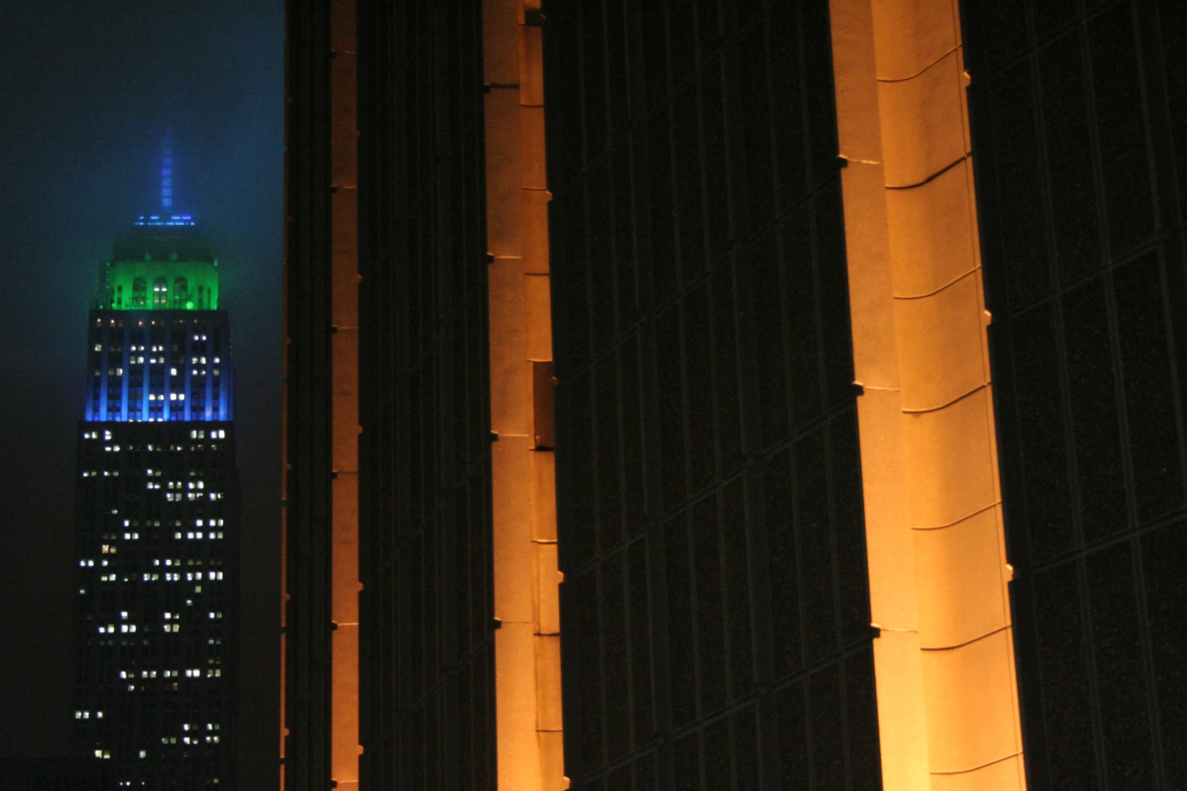 skyscrs with tall lights at night in new york