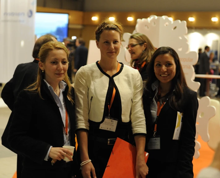 a group of three women standing next to each other