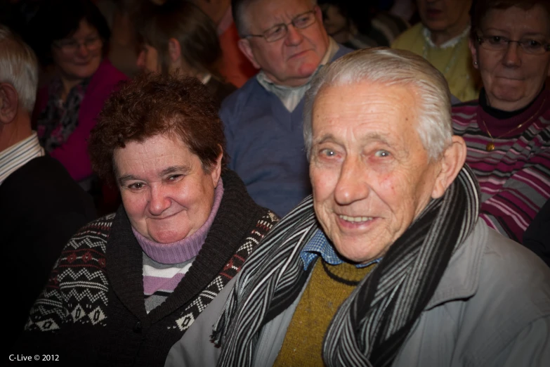 an older man and woman posing for a picture together