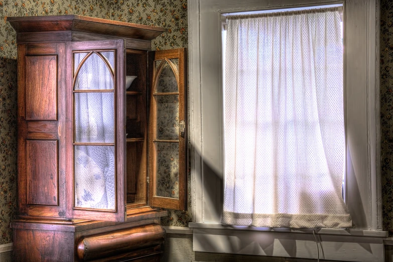 a cabinet near a window on top of a table