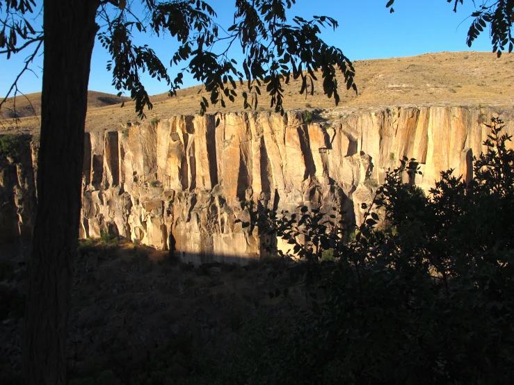 there is a rock formation on the side of a mountain