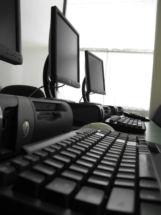 a desk with two monitors on it and two keyboard