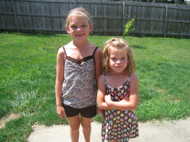 two little girls posing for a po in their swimming costumes