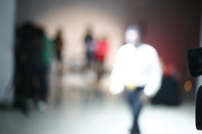 a blurry view of people standing in front of a camera