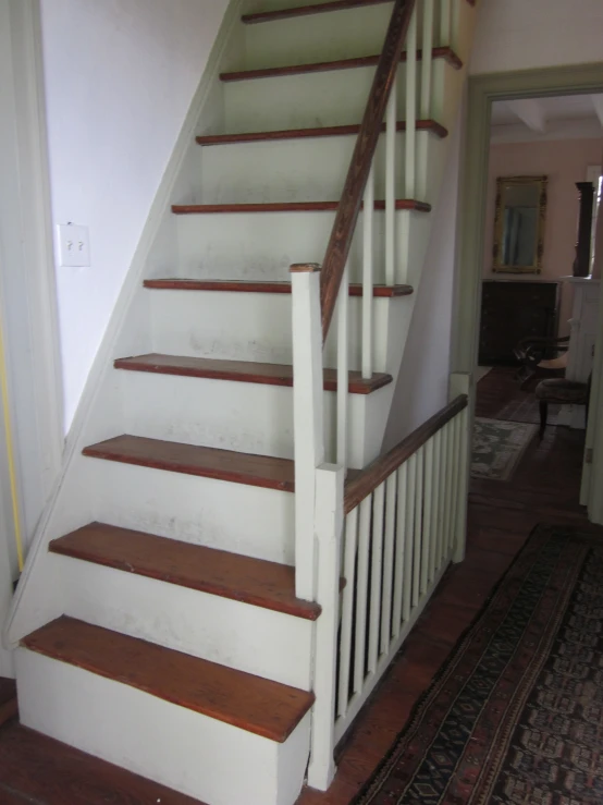 the stairs leading to an open area in a home