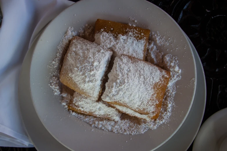 powdered sugar filled pieces of french toast in a bowl