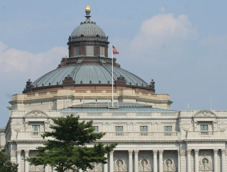the building is in an ornate pattern and a very large flag on top