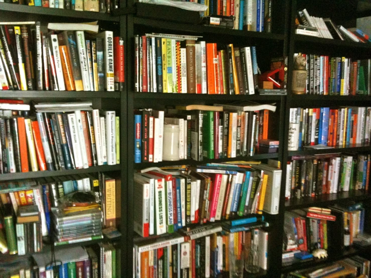 many books are stacked up against a wall