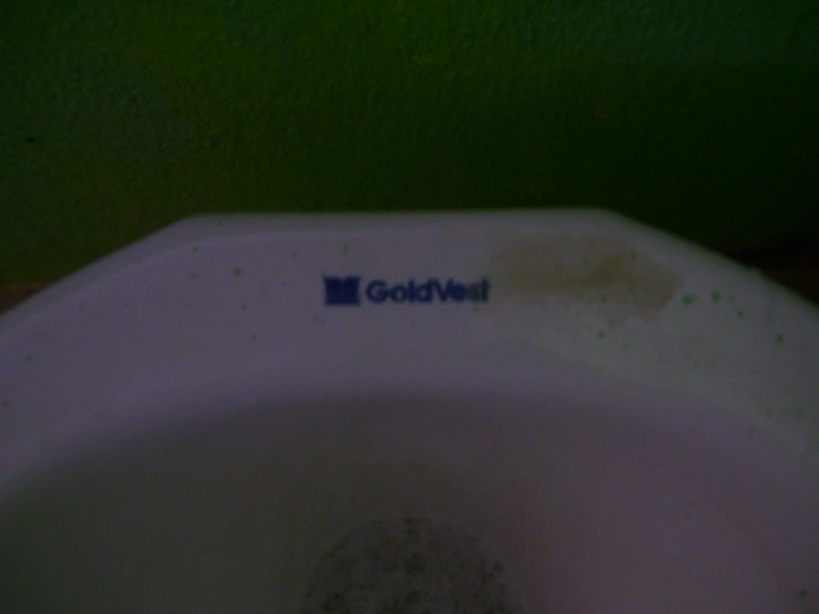 the side view of a toilet that has a graffiti on it