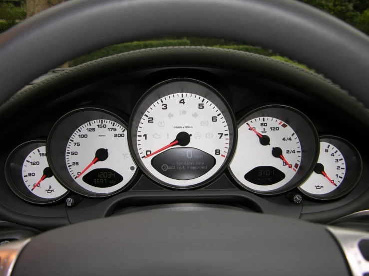 several white and black gauges inside a car