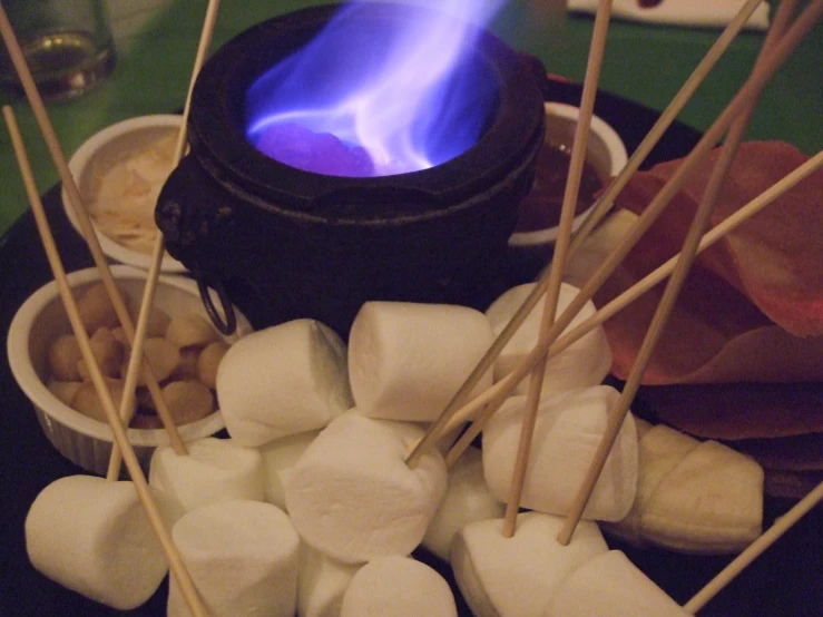 marshmallows sit on a plate in front of a stove