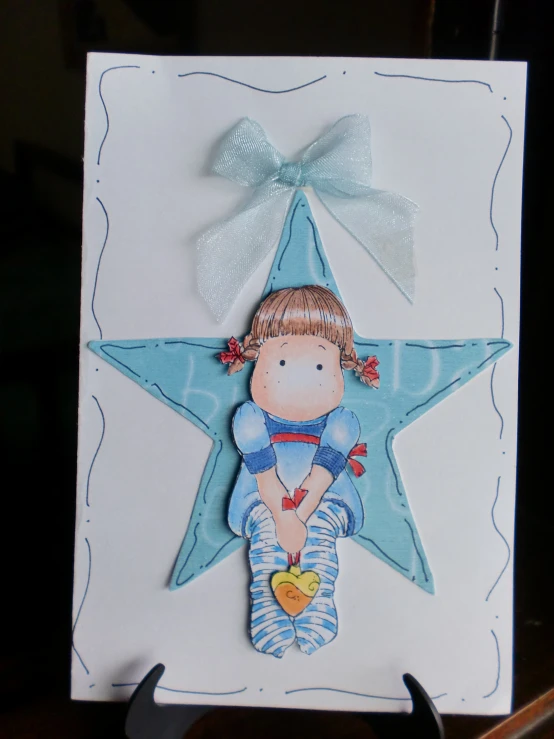 there is a drawing of a little girl sitting on a star