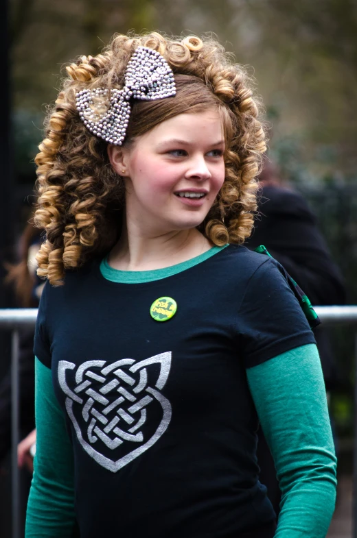 a  with curly hair and a green shirt