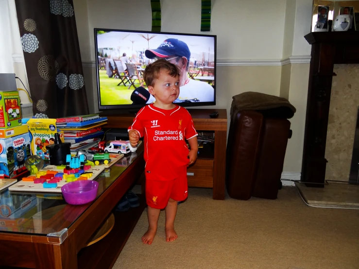 a boy playing with his toys in a living room