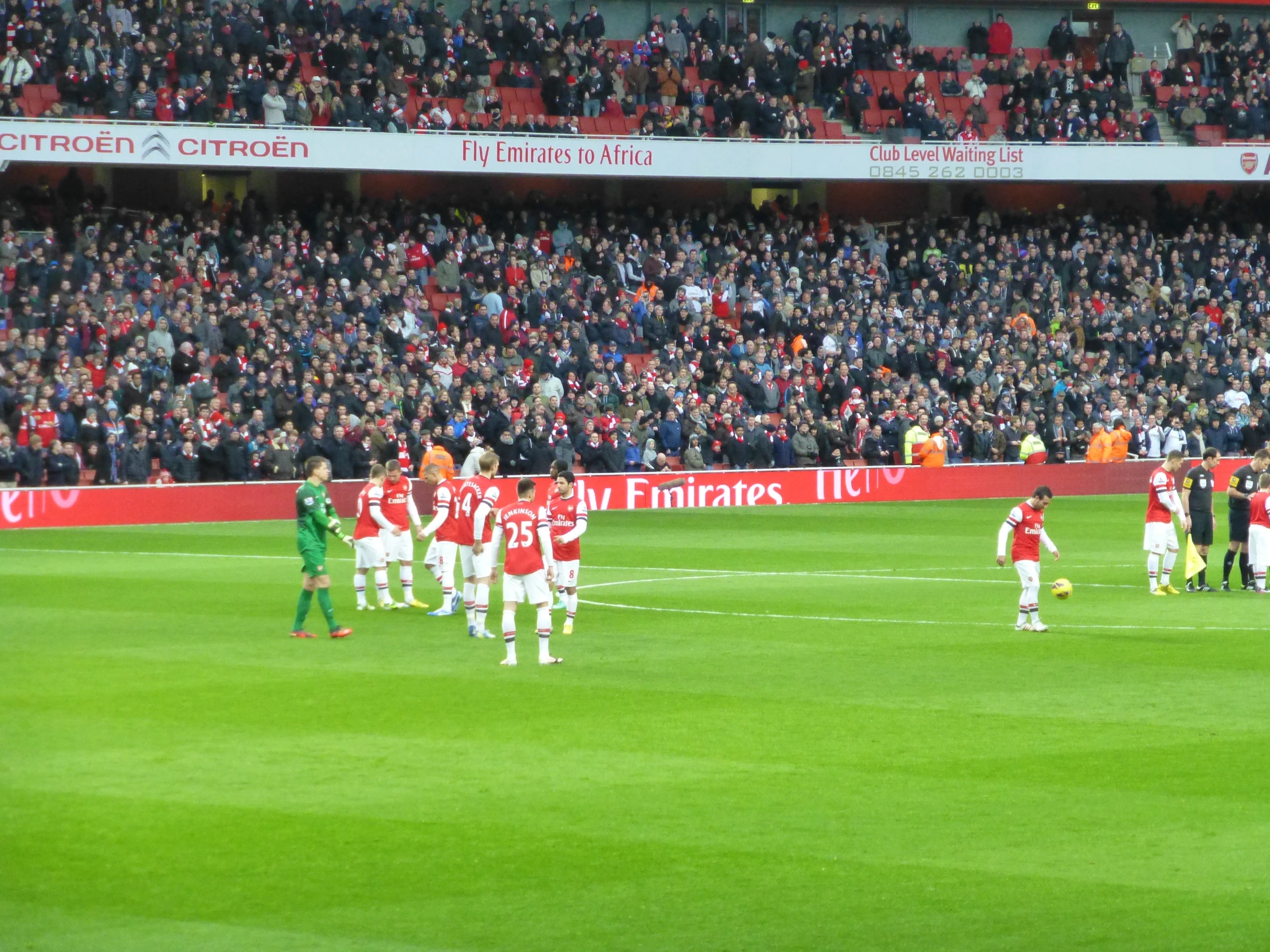 people in a large stadium playing soccer