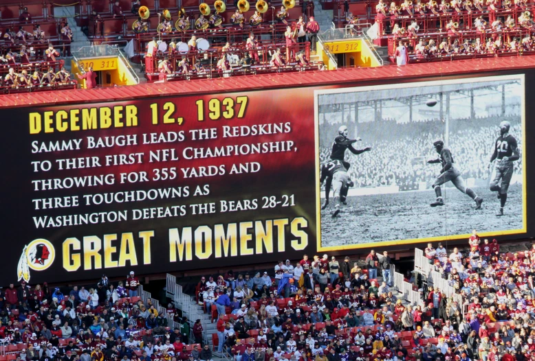 a giant scoreboard with a pograph of a baseball game at great moments