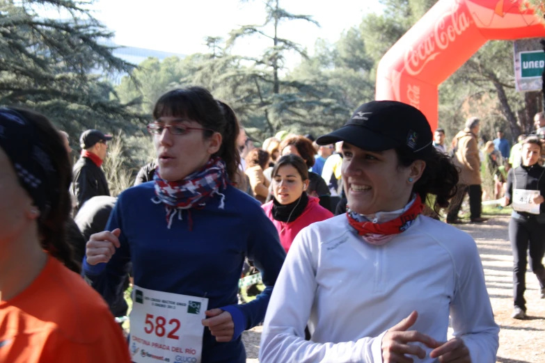 two people are at a marathon with a red ribbon around their neck