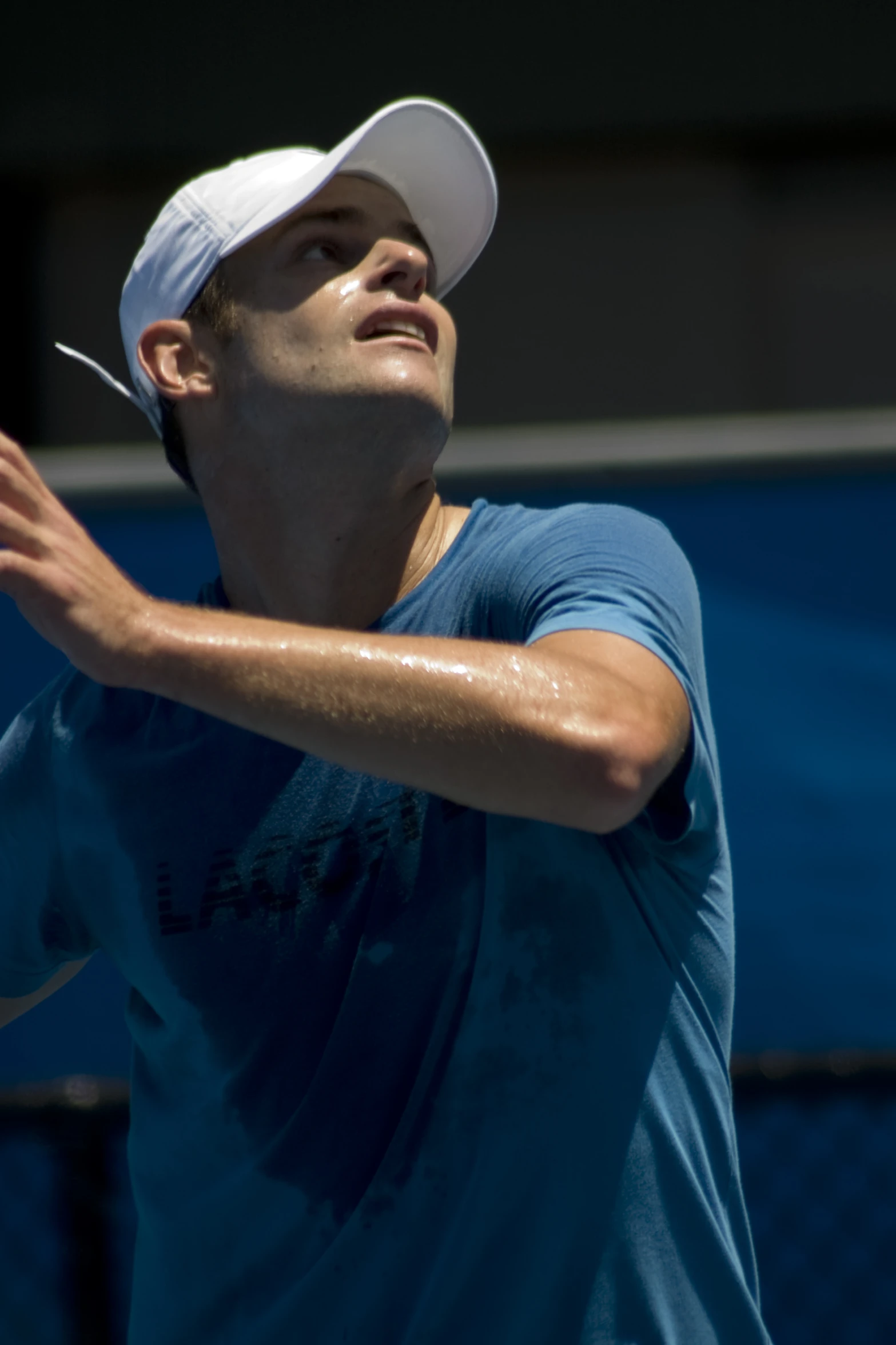 a man getting ready to hit the tennis ball with his racket
