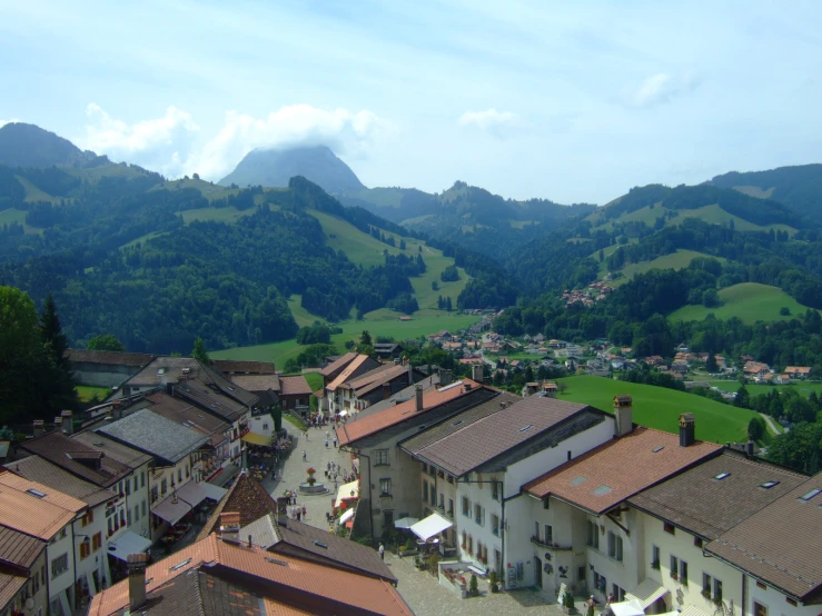 a city has many old buildings near the mountains