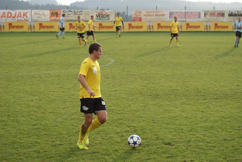 two teams of young men playing a soccer game