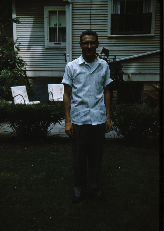 a man standing in front of a white house