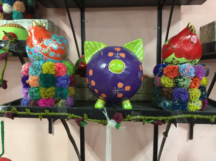 two large, colorful balloons in the shape of fish sitting on a shelf