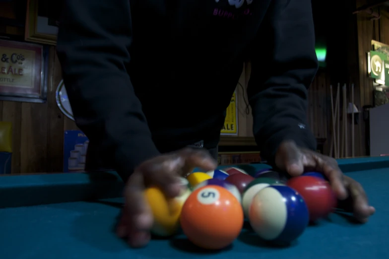 an individual is displaying some billiards colorful pool balls