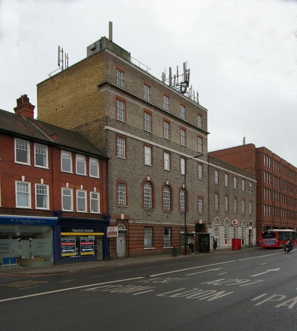 the city block has many windows and one street is empty