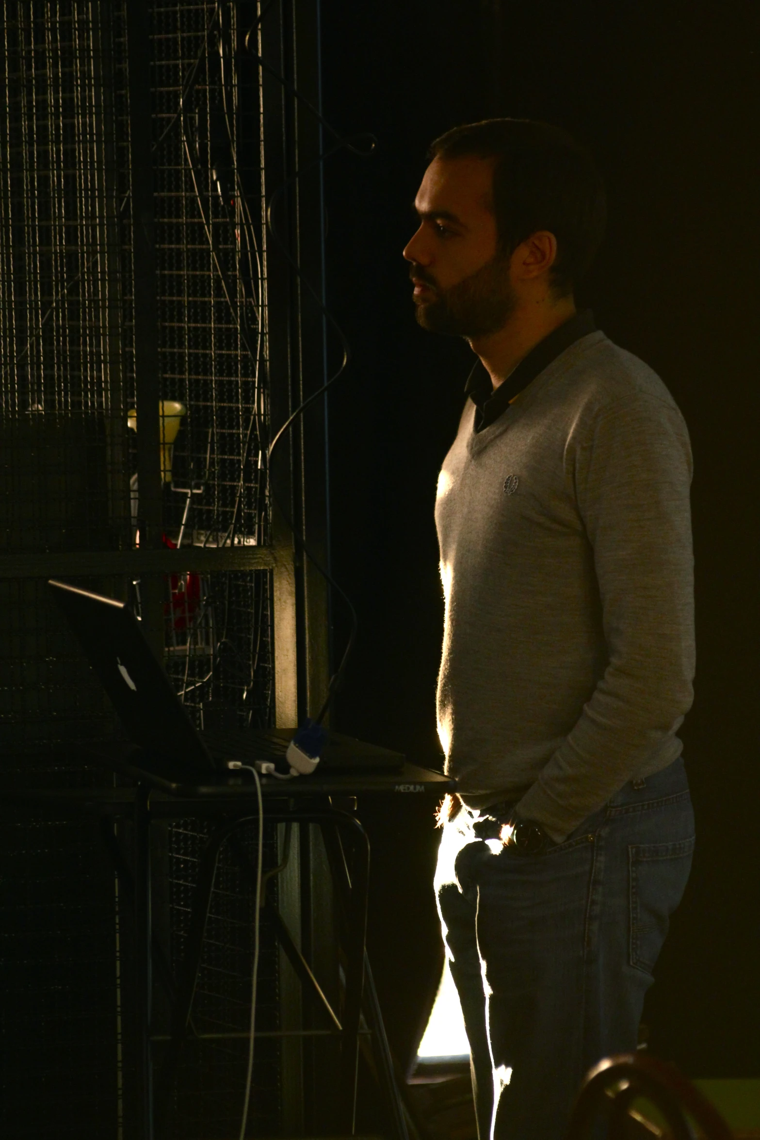 a man standing next to a laptop computer