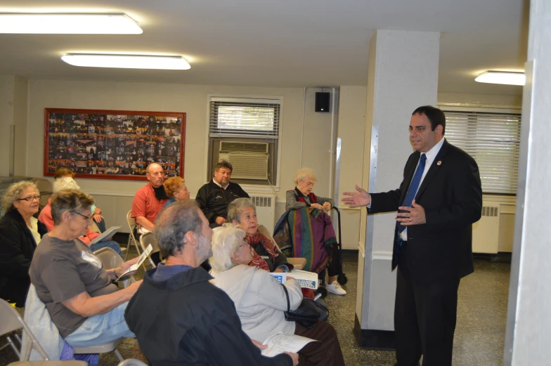 an older person giving a presentation to a group