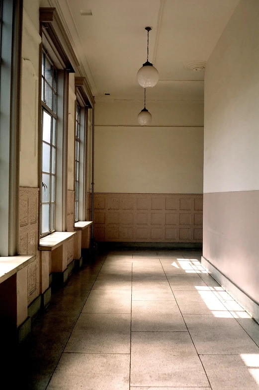 a hallway with windows and long benches lined up