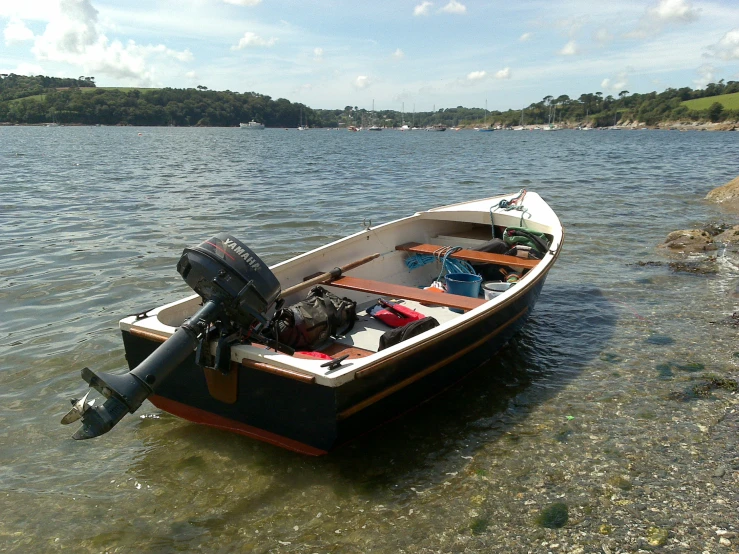 a boat on a lake surrounded by rocks and trees