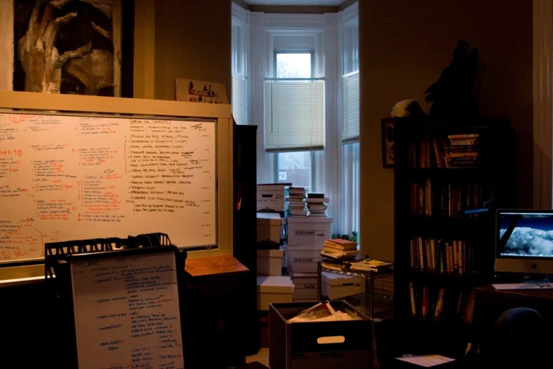 a very messy office with a lot of things on the desk