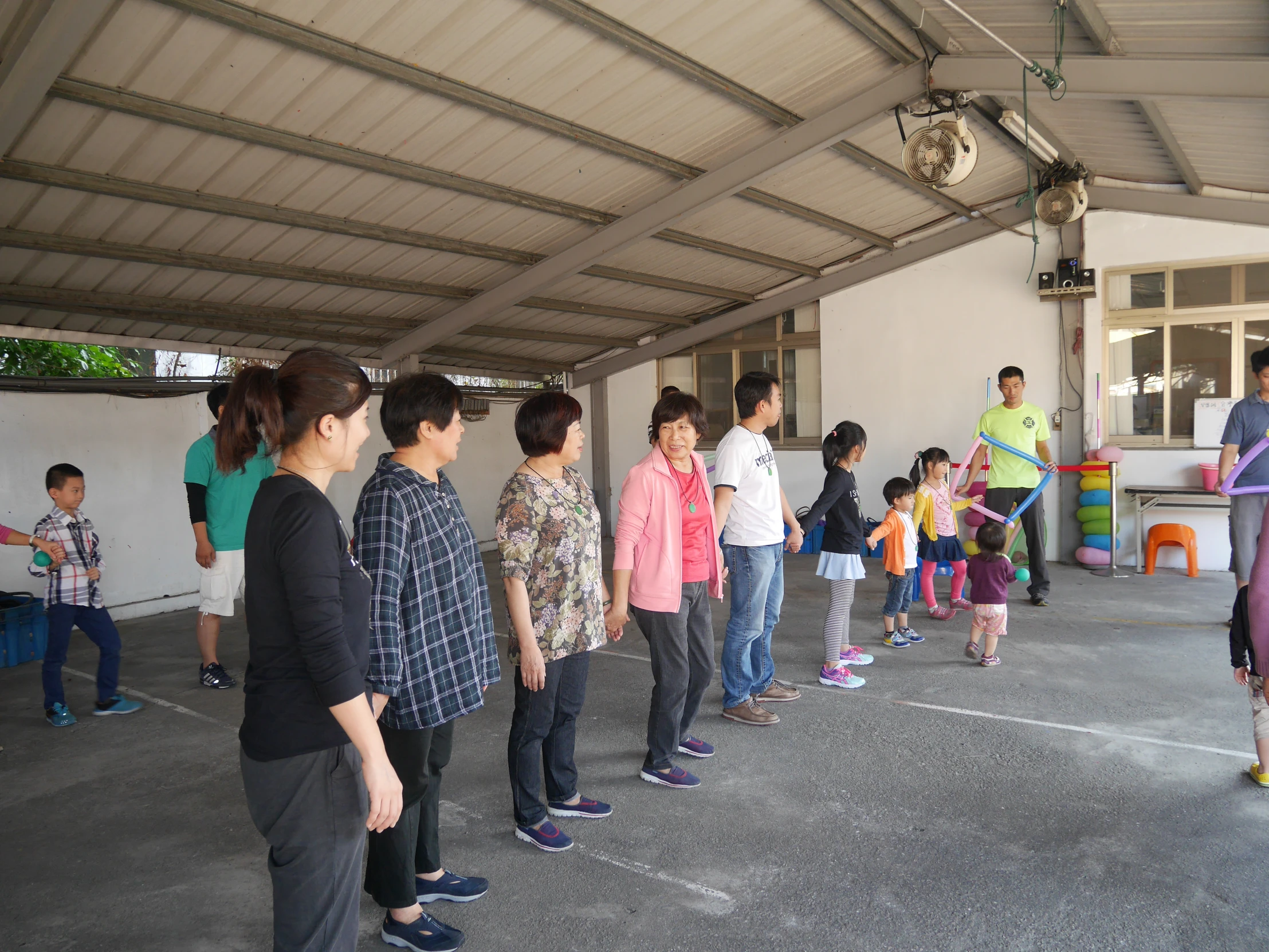 group of people standing in an empty garage