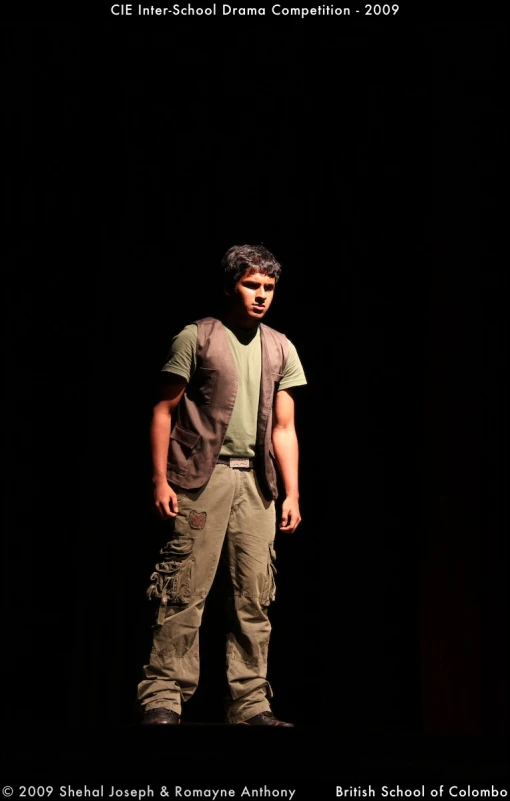 a man is standing on the stage in an empty auditorium