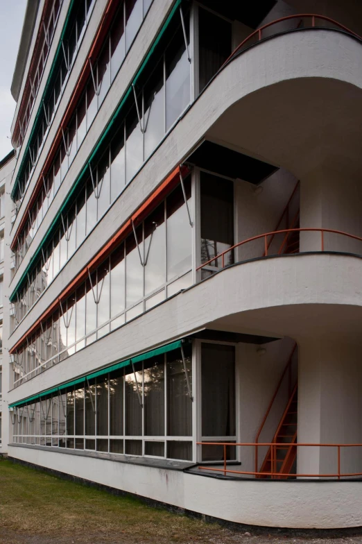 the curved balconies of a building next to another building