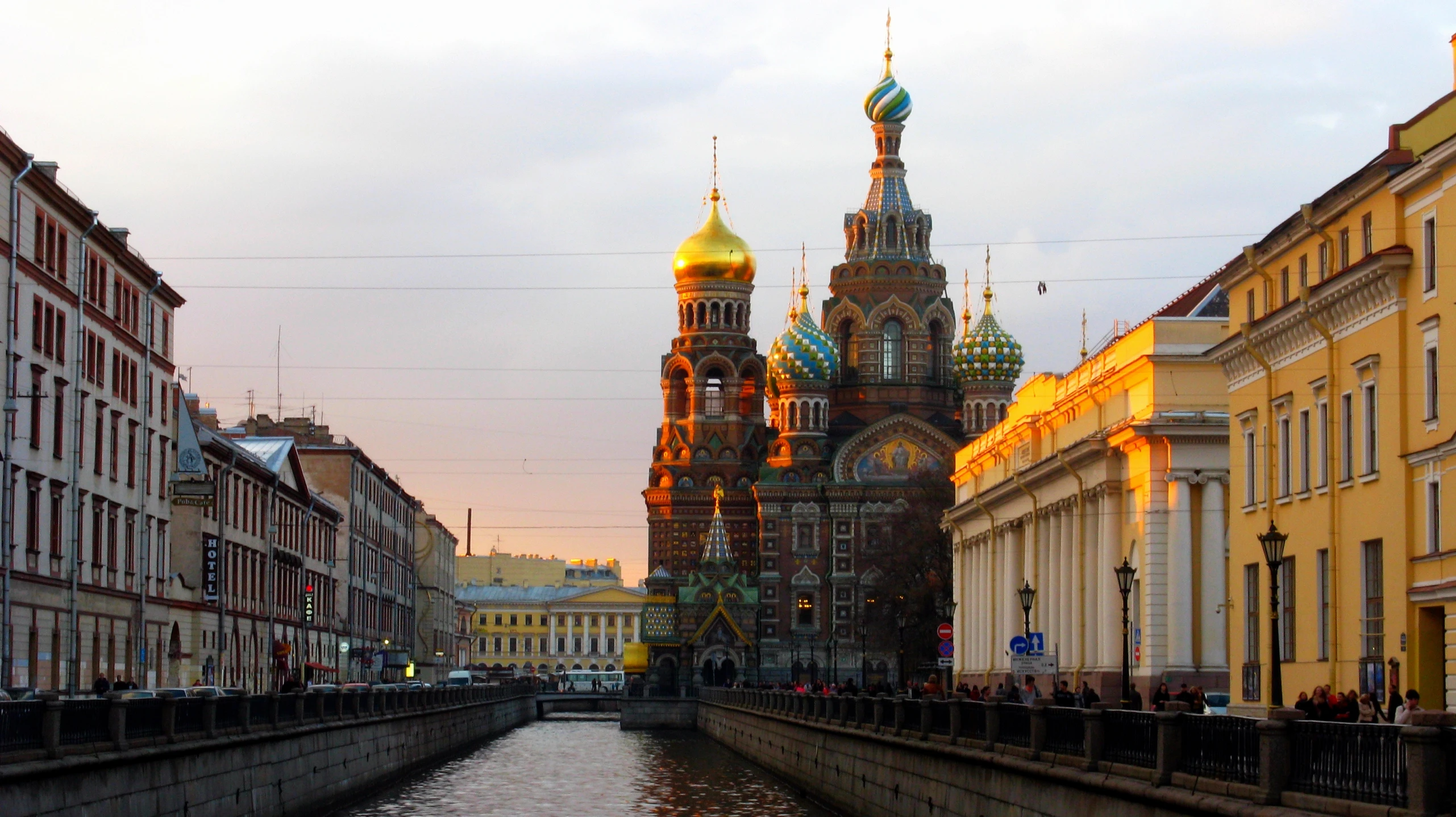 a river running through between two large buildings with towers