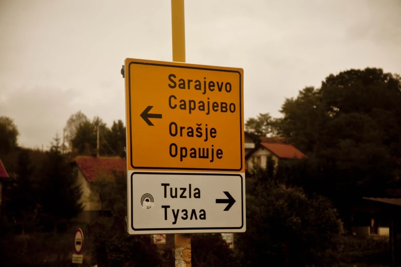 street signs in foreign language are placed on a street corner