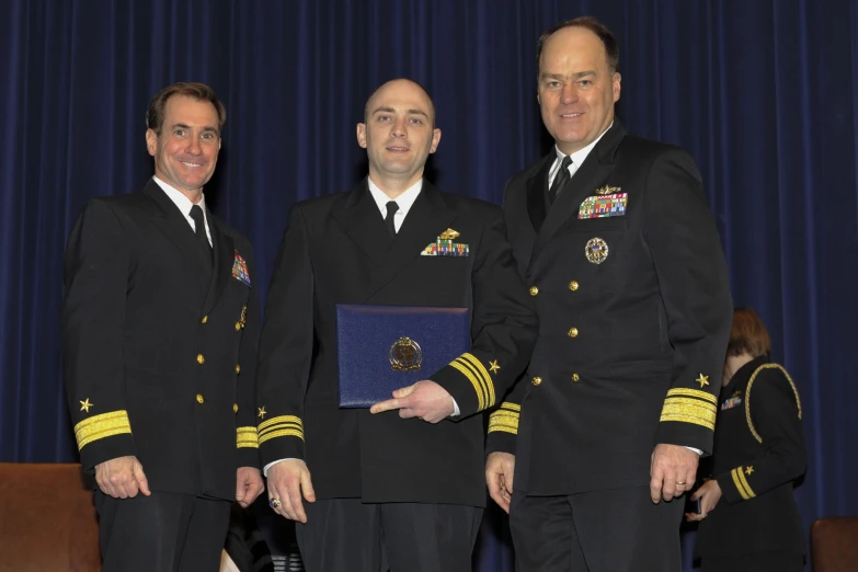 three men in suits and ties wearing medals and medals