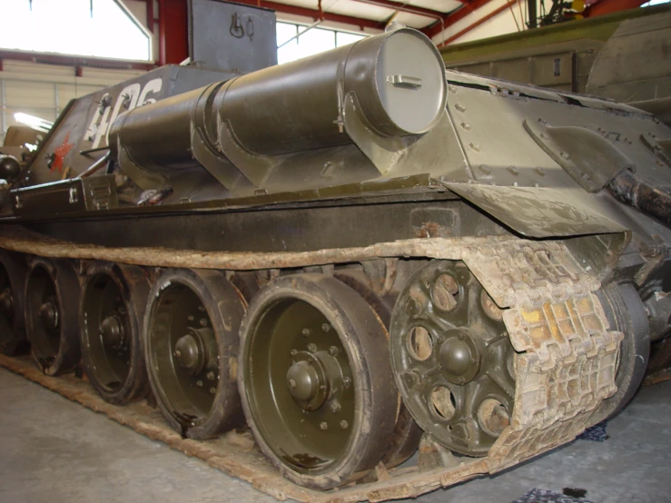 a military tank sits in the middle of a building