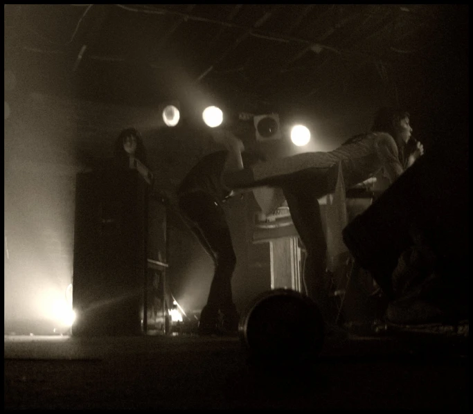 several people on stage with lights in the background