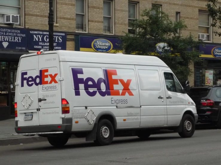 fed ex van sitting on the side of the road