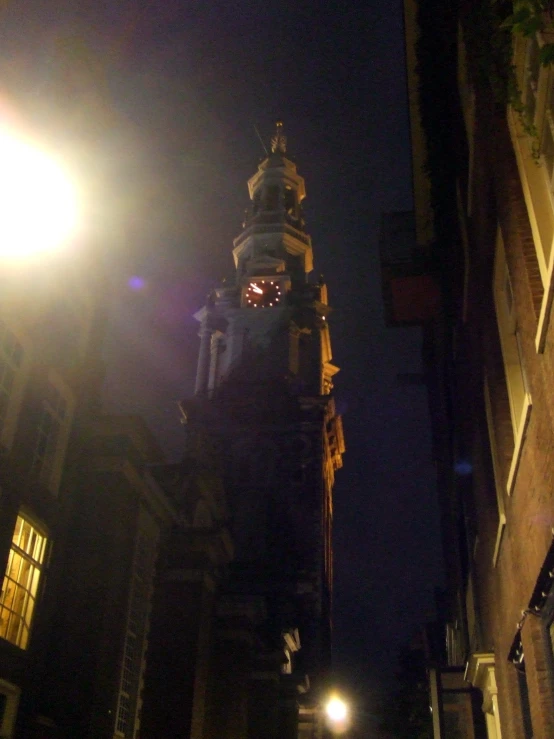 a tall clock tower sits in the middle of the night